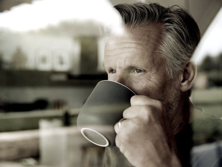 a man drinking on his mug