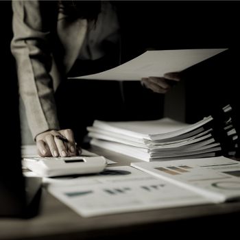 a financial planner holding a paper and calculator