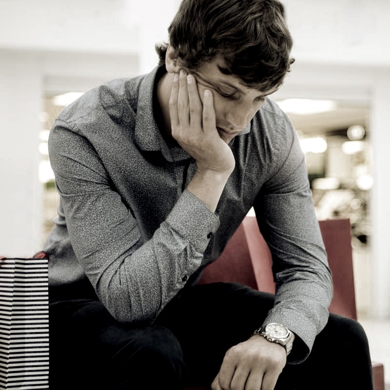 Man Sitting In Shopping Mall Min